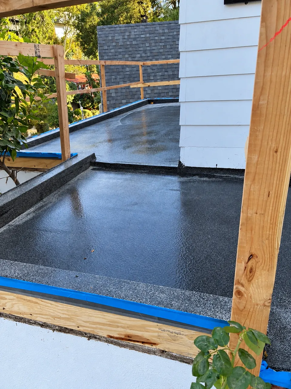 After waterproofing: dark CIM-1000 membrane on the Beverly Hills balcony with temporary timber railings