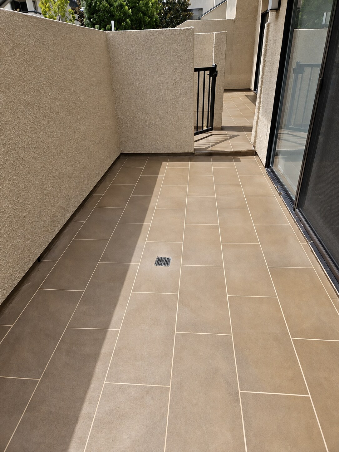 Warm taupe plank layout completed by California Decking & Waterproofing